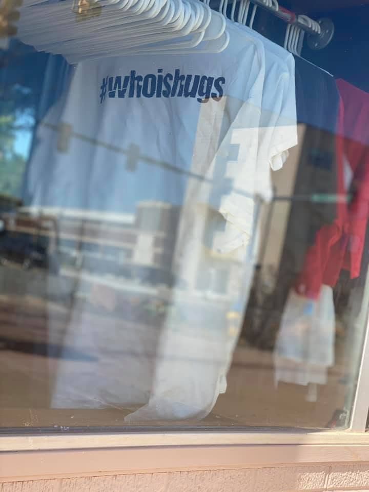 Nate Kelley wearing an orange Who Is Hugs shirt from an early merch run